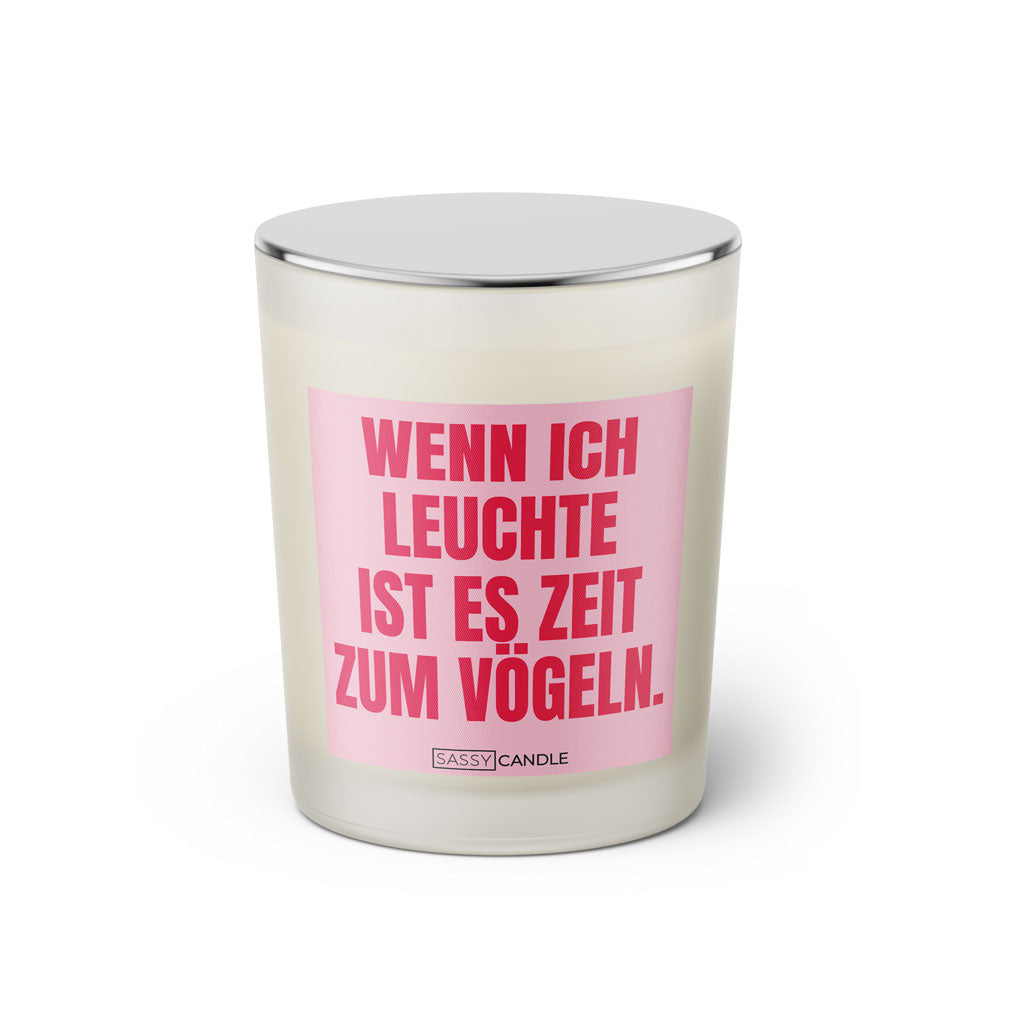 Duftkerze mit witzigem Spruch: Wenn ich leuchte ist es Zeit zum vögeln. Farbe rosa und pinke Schrift. Kerzenglas mit silbernem geschlossenem Deckel von SassyCandle.