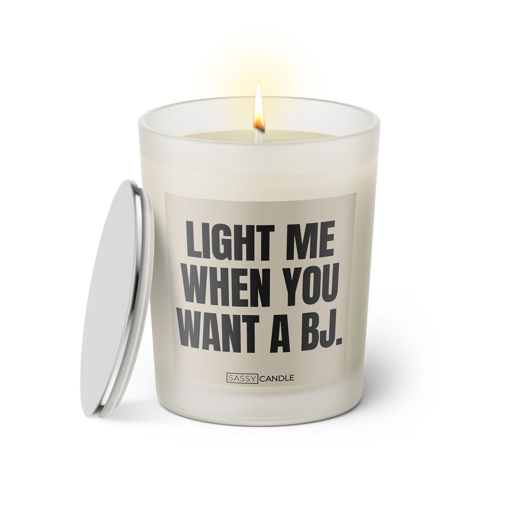 Duftkerze mit witzigem Spruch: Light me when you want a BJ. Farbe beige und schwarze Schrift. Kerzenglas mit silbernem Deckel von SassyCandle.