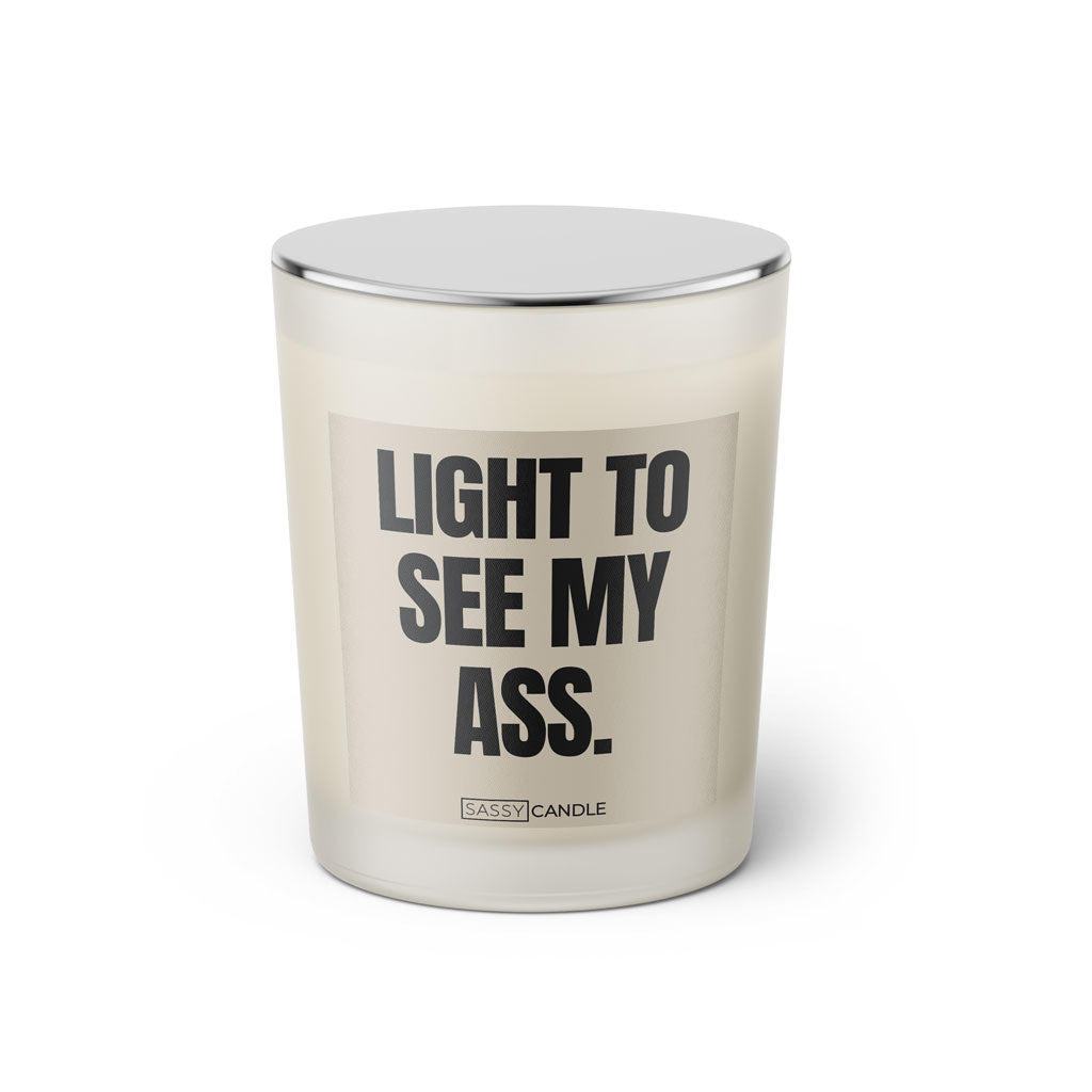 Duftkerze mit witzigen Spruch: Light to see my ass. Farbe beige und schwarz von Sassy Candle.