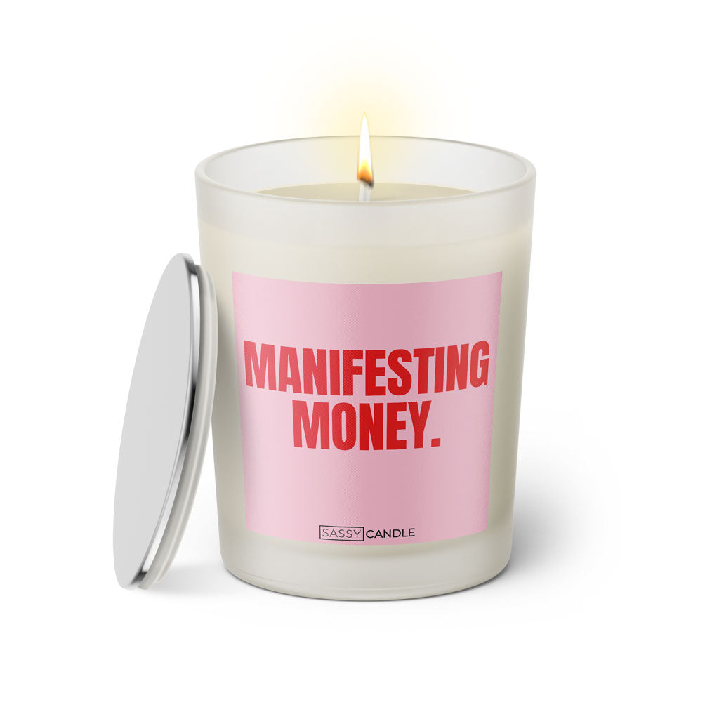 Duftkerze mit witzigem Spruch: Manifestant Money. Farbe rosa und pink Schrift. Kerzenglas mit silbernem Deckel von SassyCandle.