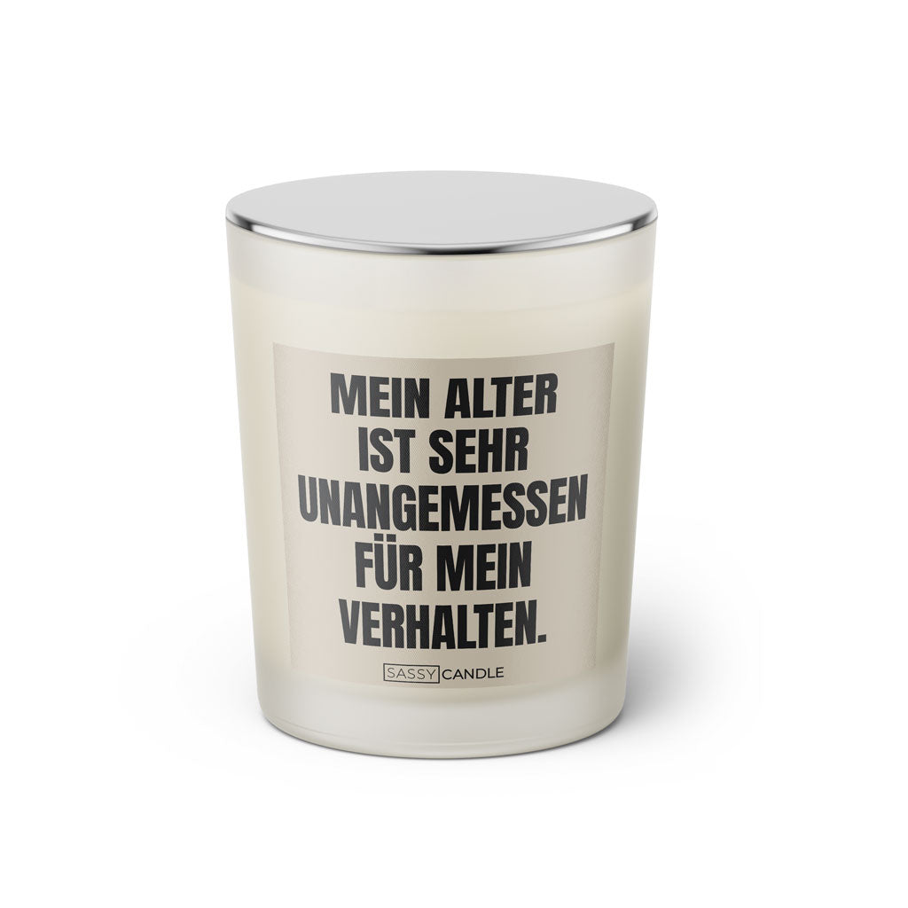 Duftkerze mit witzigen Spruch: Mein Alter ist sehr unangemessen für mein Verhalten. Kerzenglas mit silbernen Deckel. Farbe schwarz und beige von Sassy Candle.