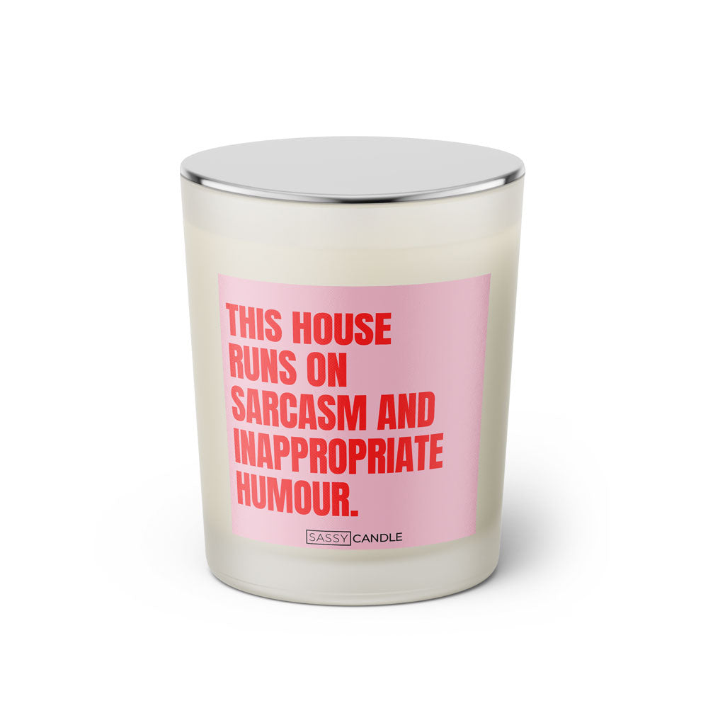 Duftkerze mit witzigen Spruch: This house runs on sarcasm and inappropriate humour. Farbe rosa und pink. Kerze von Sassy Candle.