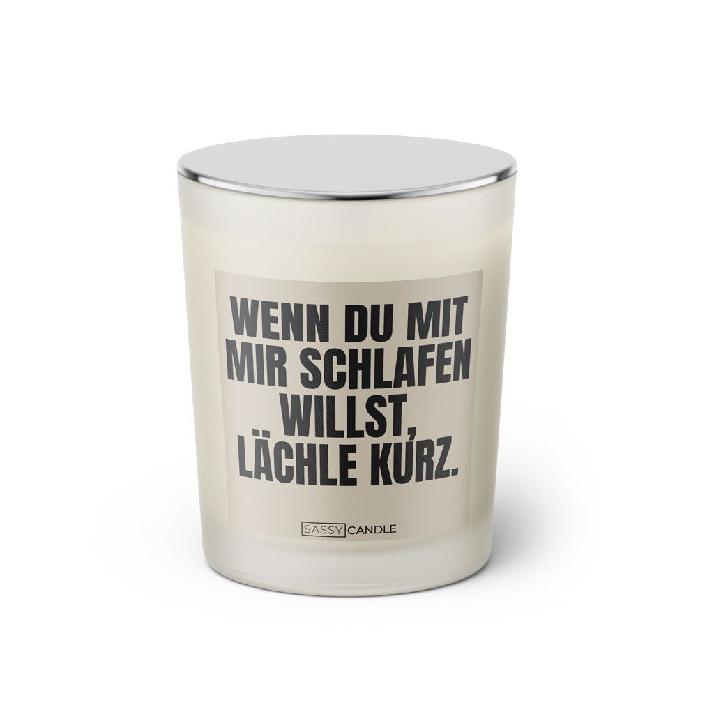 Duftkerze mit witzigem Spruch: Wenn du mit mir schlafen willst, lächle kurz. Farbe beige und schwarze Schrift. Kerzenglas mit silbernem geschlossenem Deckel von SassyCandle.
