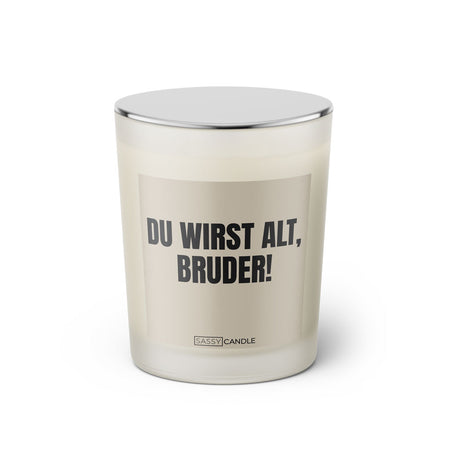 Duftkerze mit witzigem Spruch: Du wirst alt Bruder. Farbe beige und schwarze Schrift. Kerzenglas mit silbernem geschlossenem Deckel von SassyCandle.