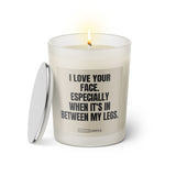 Duftkerze mit Spruch: I love your face. Especially when it's in between my legs. Farbe beige und schwarz von Sassy Candle.