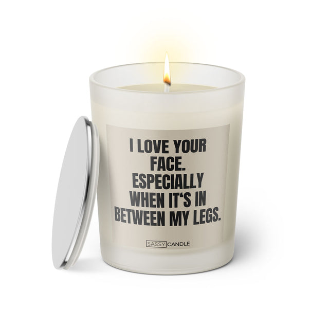 Duftkerze mit Spruch: I love your face. Especially when it's in between my legs. Farbe beige und schwarz von Sassy Candle.
