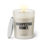 Duftkerze mit witzigem Spruch: Manifestant Money. Farbe beige und schwarze Schrift. Kerzenglas mit silbernem Deckel von SassyCandle.